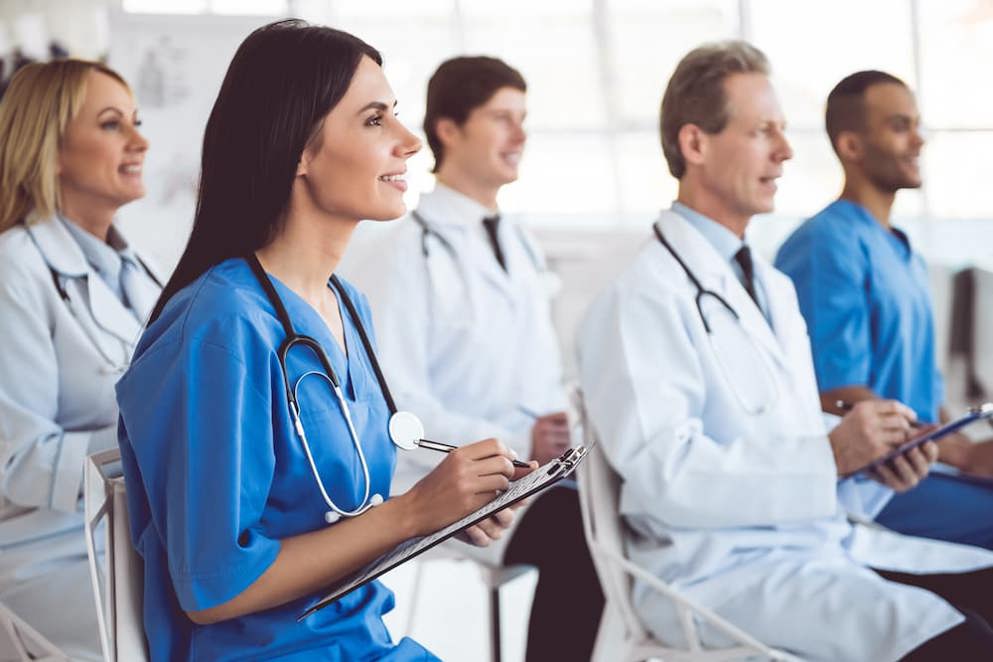 Group of doctors and healthcare professionals taking notes